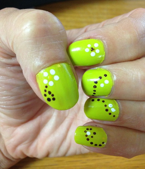Green Nail Art With Black And White Polka Dots Flower Nail Design