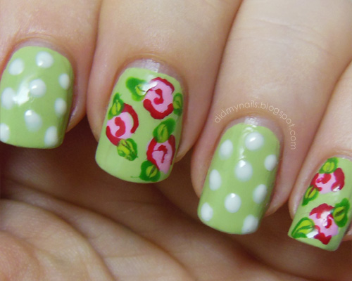 Green Nails With Pink Flowers And White Polka Dots Nail Art
