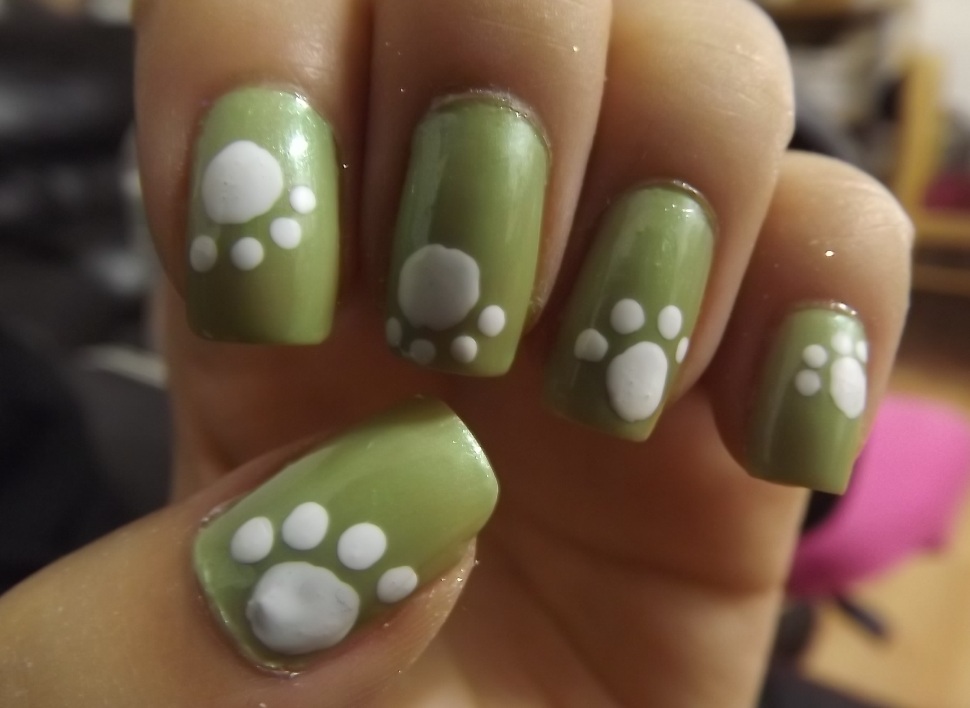 Green Nails With White Paw Print Nail Art