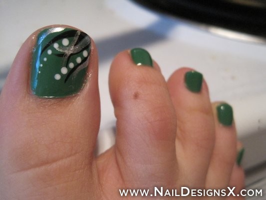 Green Toe Nails With Black Stripes And White Dots Design