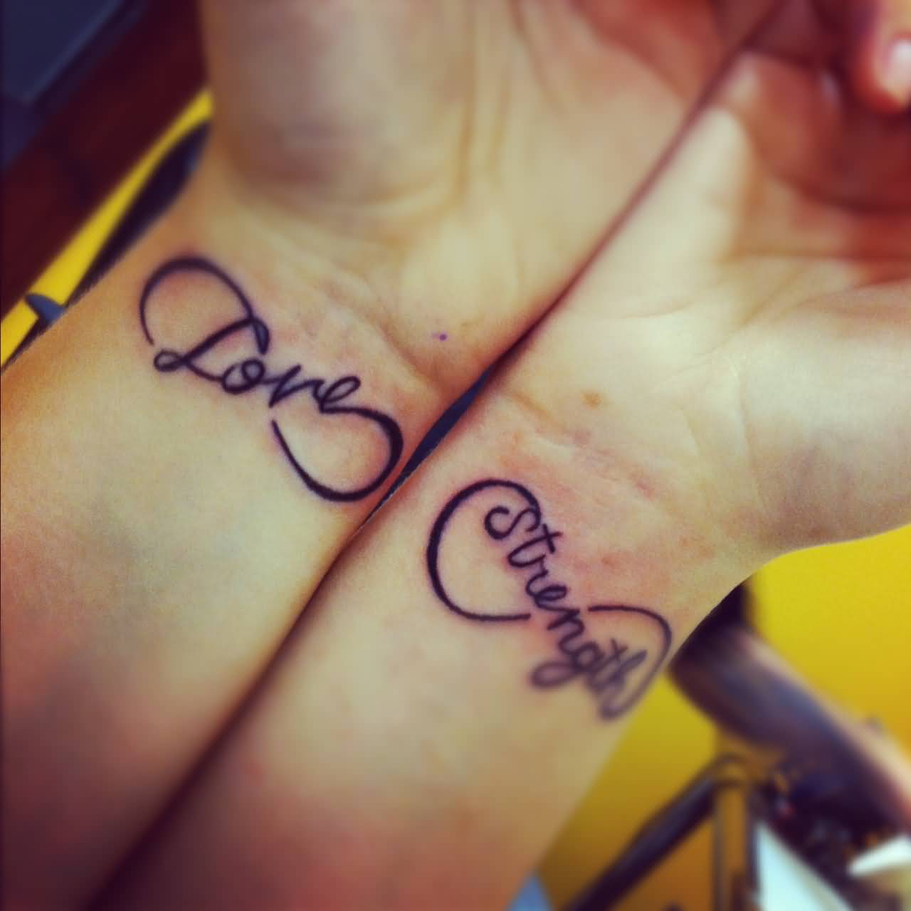 Infinity Love And Strength Tattoos On Both Wrists