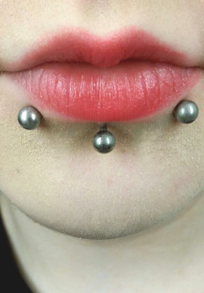 Labret And Horizontal Lip Piercing With Silver Studs.