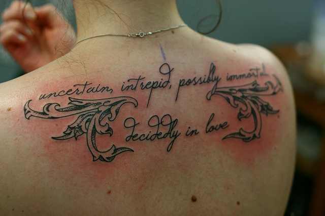 Lovely Love Quote Tattoo On Upper Back For Women