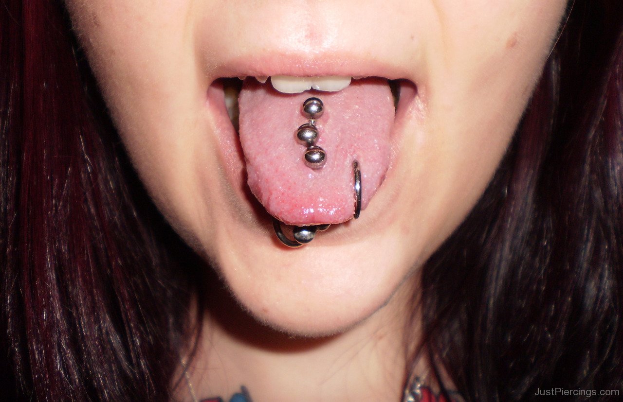Lower Lip And Multiple Tongue Piercing With Studs And Ring