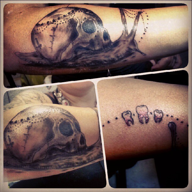 Molar And Grey Ink Skull Snail Tattoo