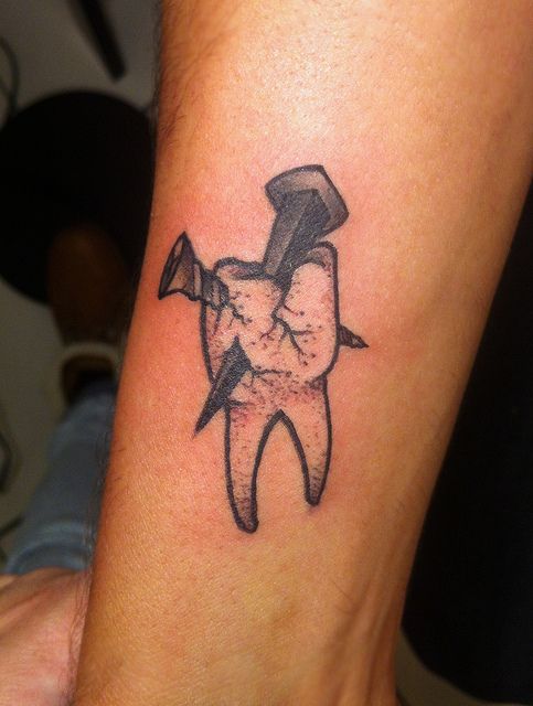 Molar Tooth With Nail Tattoo