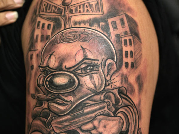 Nice Gangsta Clown In City Tattoo On Left Shoulder
