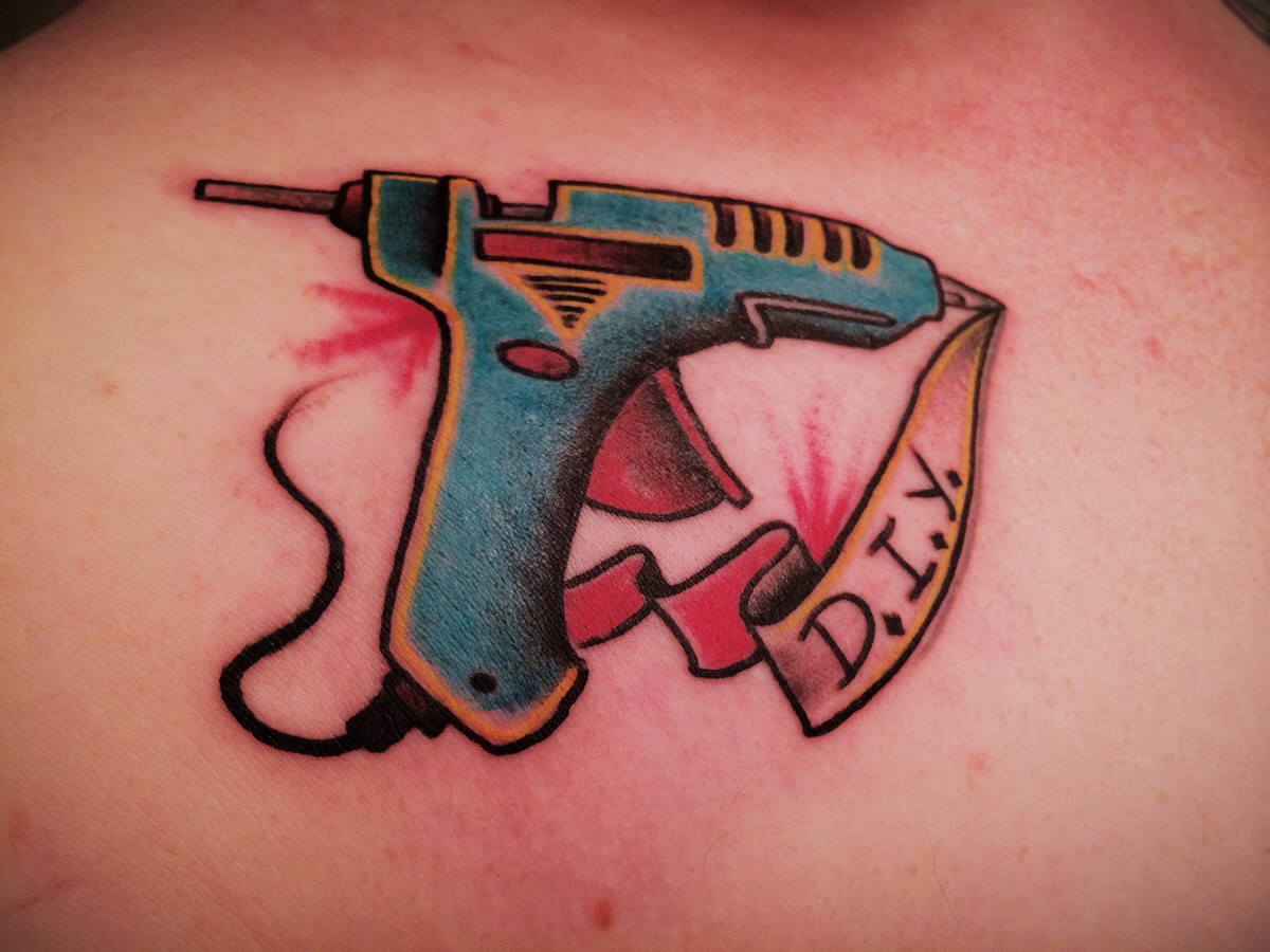 Nice Glue Gun With Banner Tattoo
