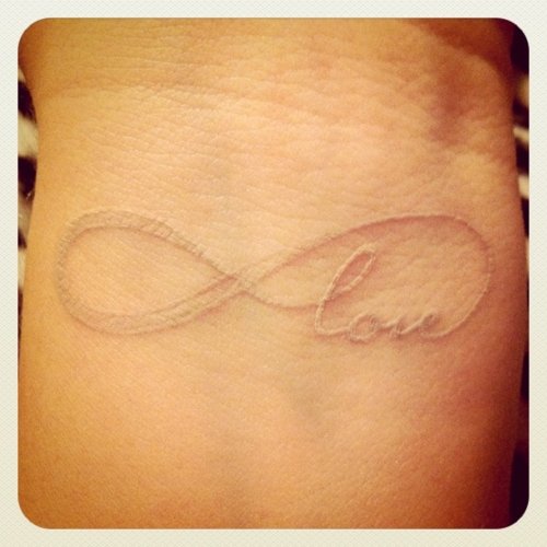 Nice White Ink Infinity Love Tattoo On Wrist