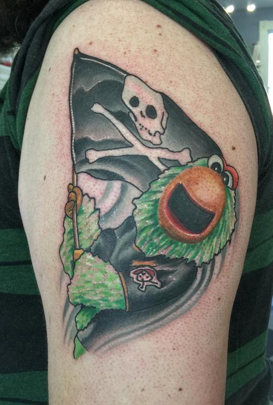 Parrot Holding Jolly Roger Flag Tattoo On Left Half Sleeve