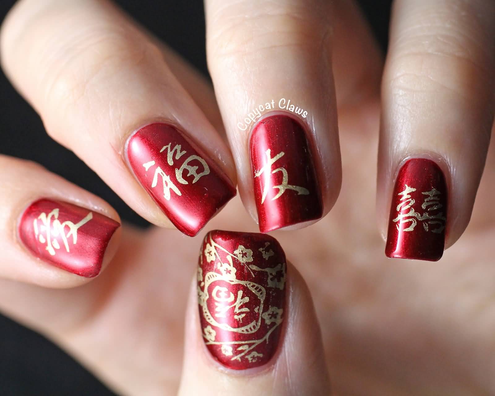 Red Nails With Chinese Symbols Nail Art