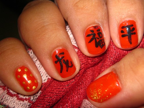 Red Nails With Gold Polka Dots And Black Chinese Symbols Nail Art
