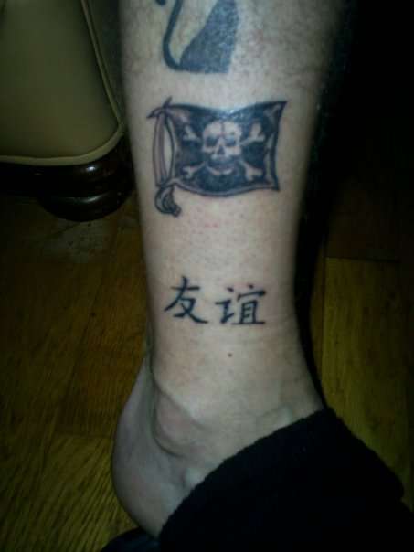 Small And Simple Jolly Roger Flag Tattoo On Leg