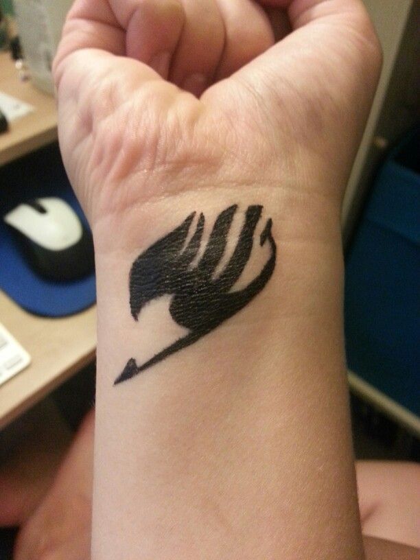 Small Black Fairy Tail Logo Tattoo On Wrist