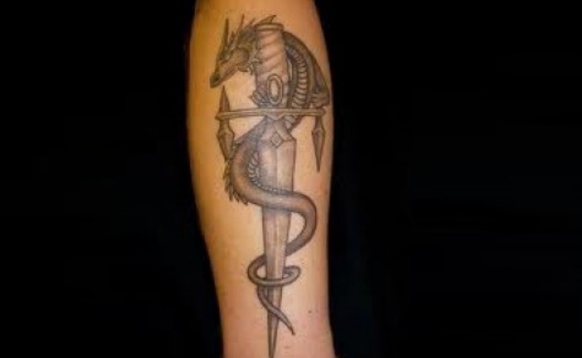 Small Grey Dragon And Dagger Tattoo