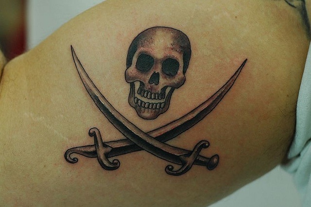 Small Grey Jolly Roger Tattoo On Biceps