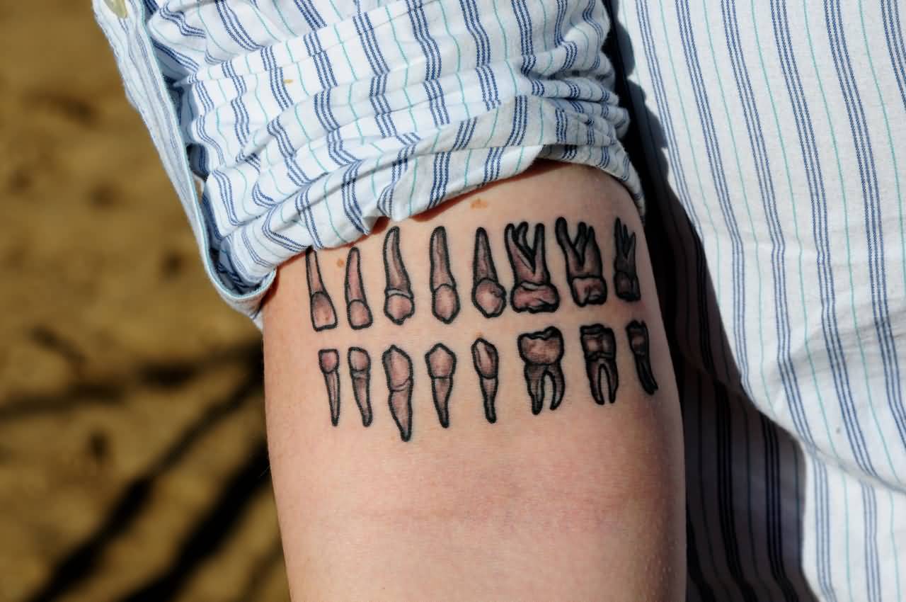 Small Grey Molar And Other Teeth Tattoo On Forearm