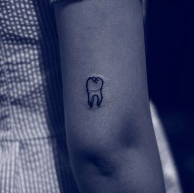 Small Molar Tooth Tattoo On Triceps