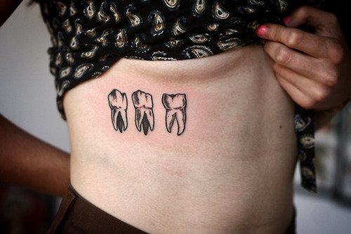 Three Molar Teeth Tattoo On Side Rib For Women