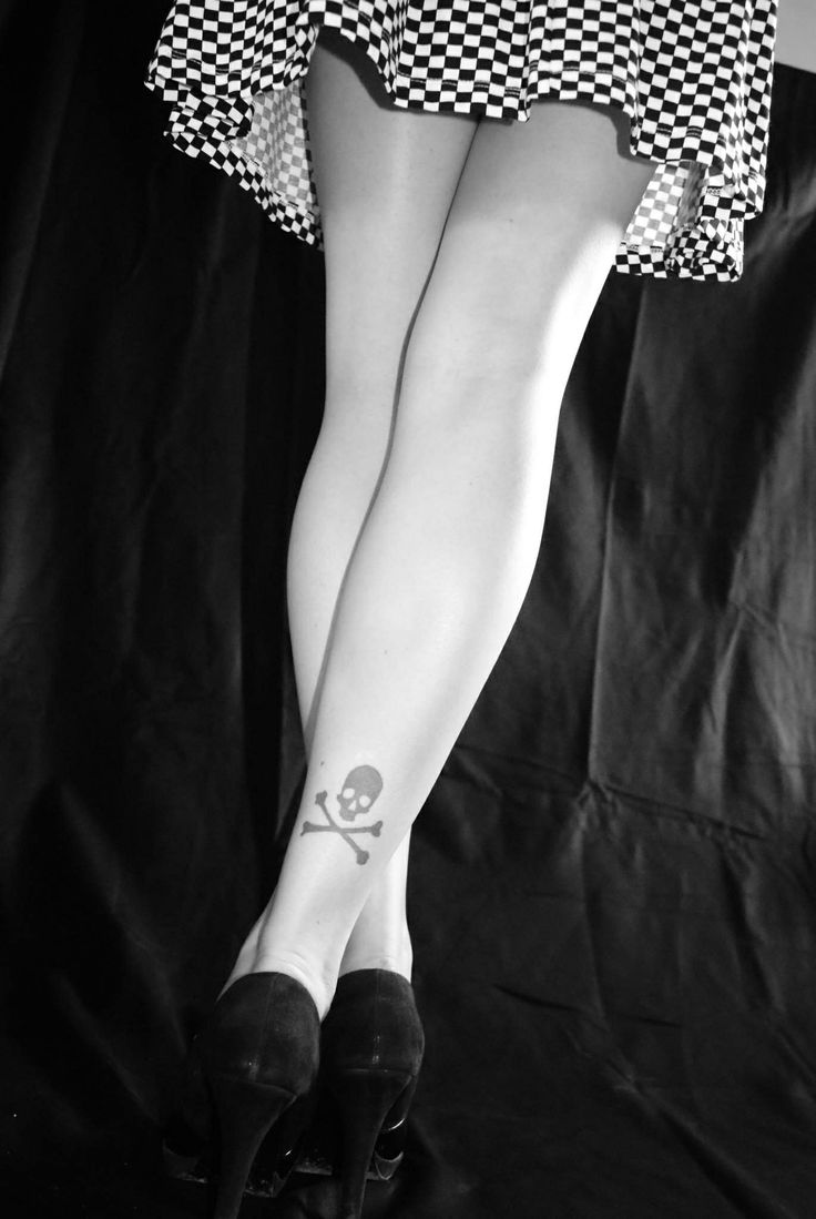 Tiny Jolly Roger Tattoo On Back Leg
