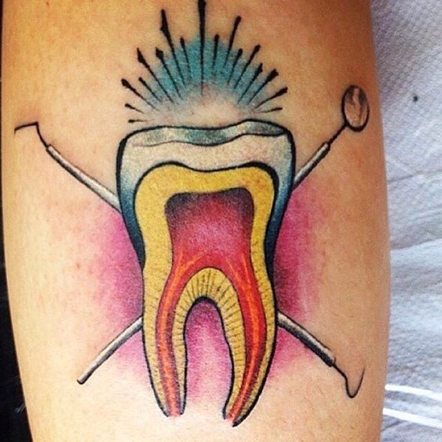 Unique Molar With Pulse And Golf Stick Tattoo