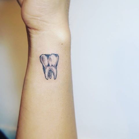 White Molar Tooth Tattoo On Wrist
