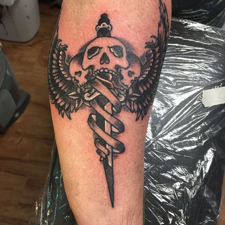 Winged Medical Symbol Style Dagger Skull Tattoo