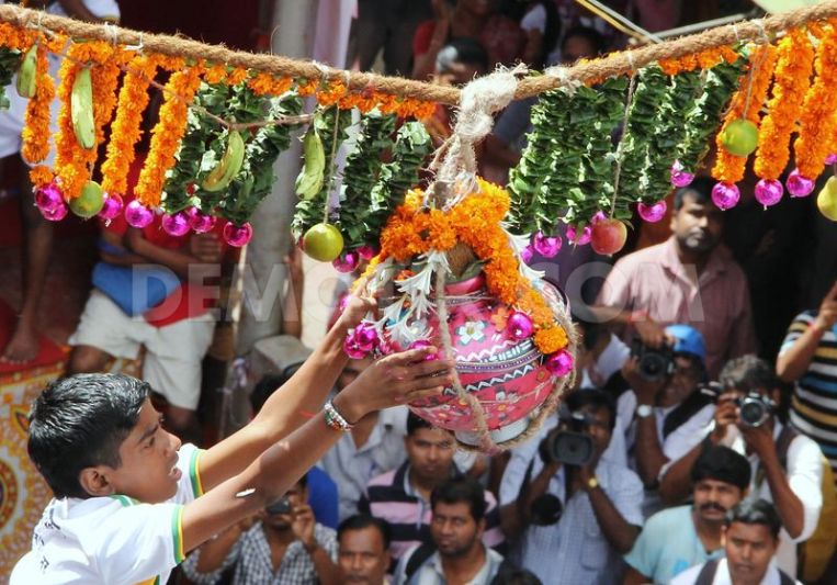 A Boy Trying To Break Dahi Handi During Krishna Janamashtmi Festival