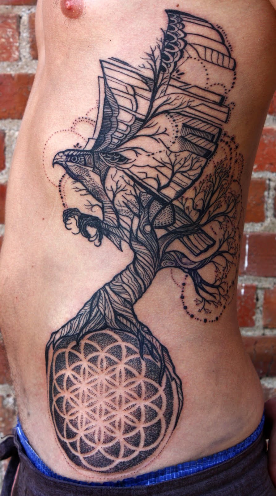 An Eagle With Tree Of Life And Mandala Flower Tattoo On Side Rib For Men