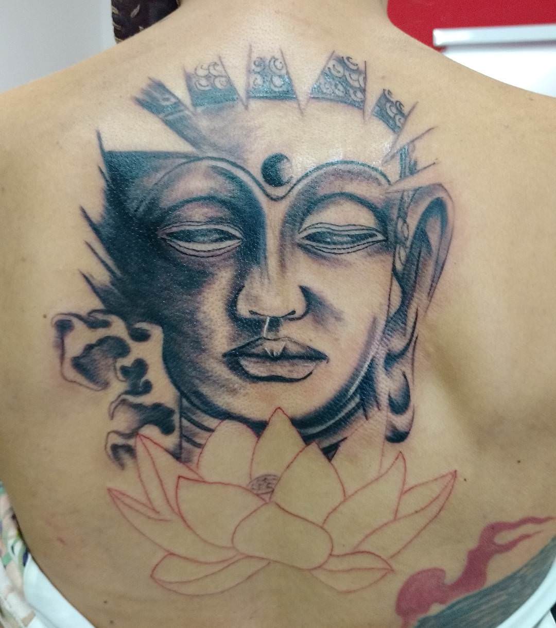 Attractive Buddha Face Spiritual Tattoo On Upper Back