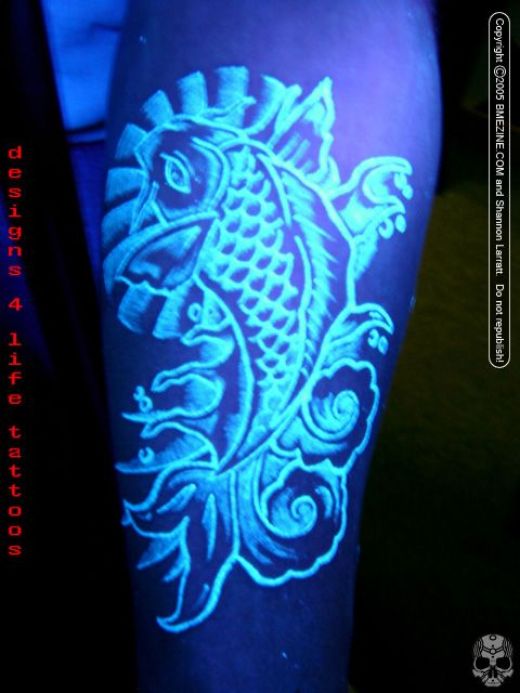 Awesome Fish UV Tattoo On Arm Sleeve