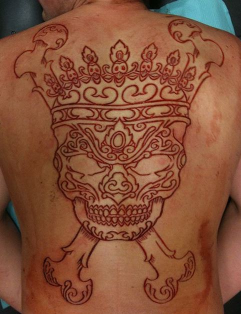 Awesome Skull With Crown Scarification Tattoo On Back
