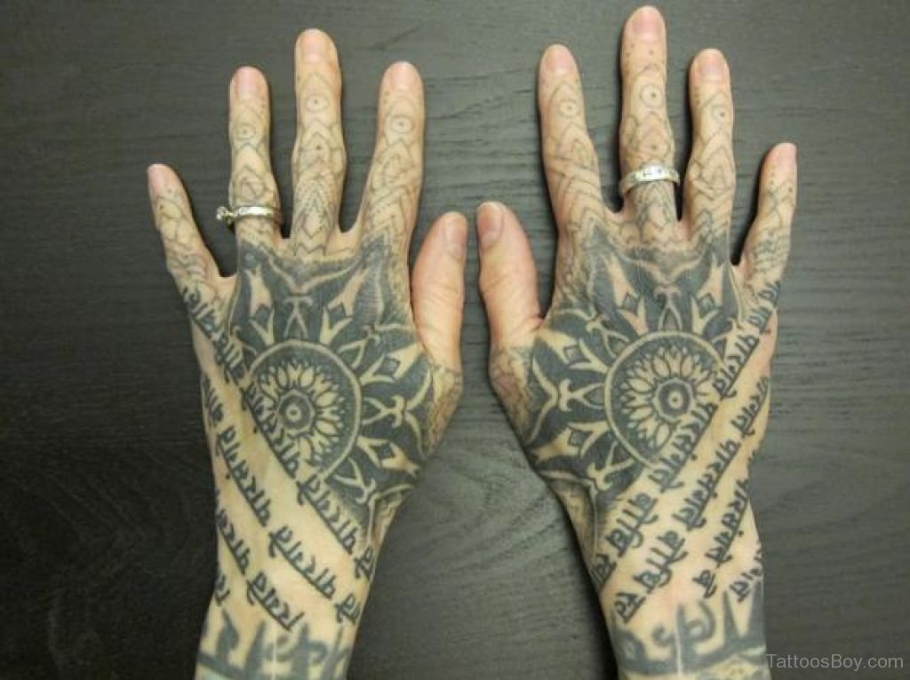 Awesome Tibetan Script With Flower Symbol Tattoo On Hands