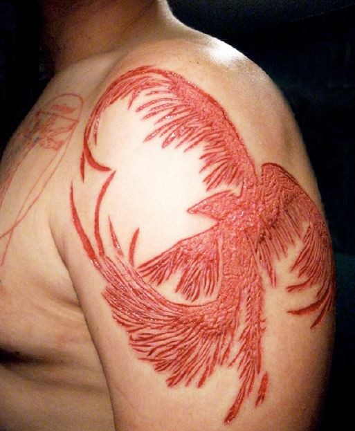 Beautiful Phoenix Skin Scarification Tattoo On Left Shoulder