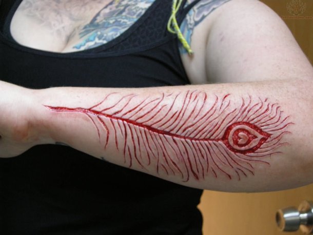 Big Scarification Feather Tattoo On Arm Sleeve