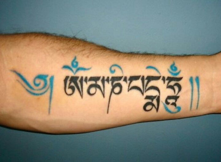 Black And Blue Om Mani Padme Hum Tibetan Tattoo On Forearm