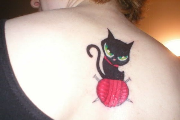 Black Cat With Yarn Tattoo On Upper Back