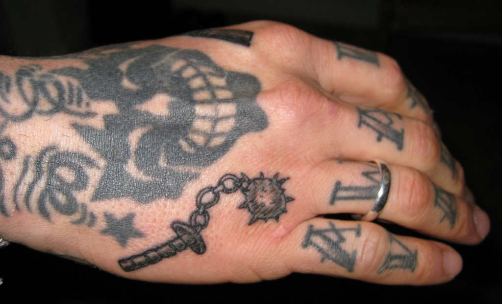 Black Small Weapon Tattoo On Hand