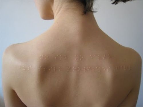 Bralie Scarification Tattoo On Upper Back