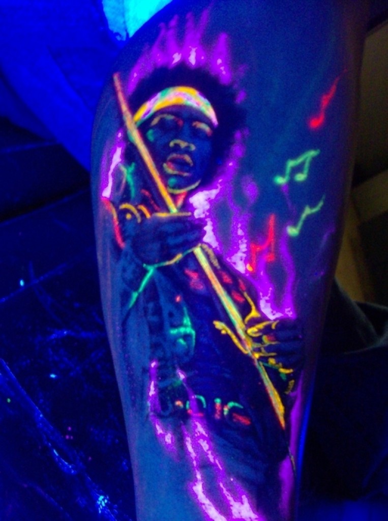 Brilliant Guitar Player UV Tattoo On Thigh