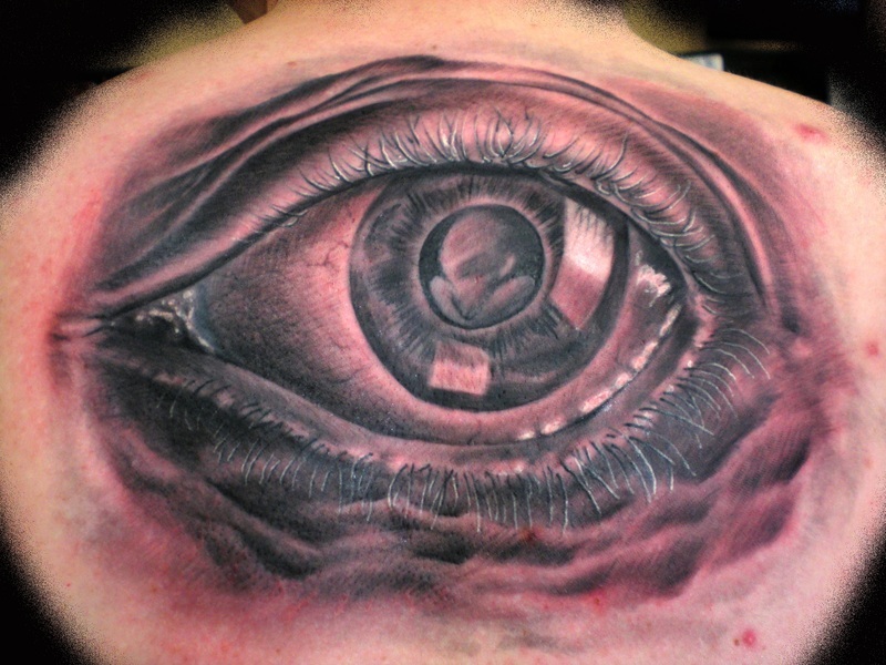 Brilliant Large Eye Escher Tattoo On Upper Back