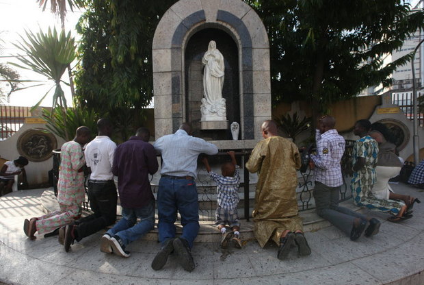 Catholics Praying At The Statue Of The Virgin Mary On The Celebration Of Assumption In Nigeria