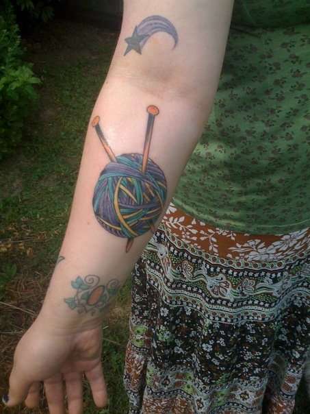 Colorful Yarn Knitting Needles Tattoo On Forearm