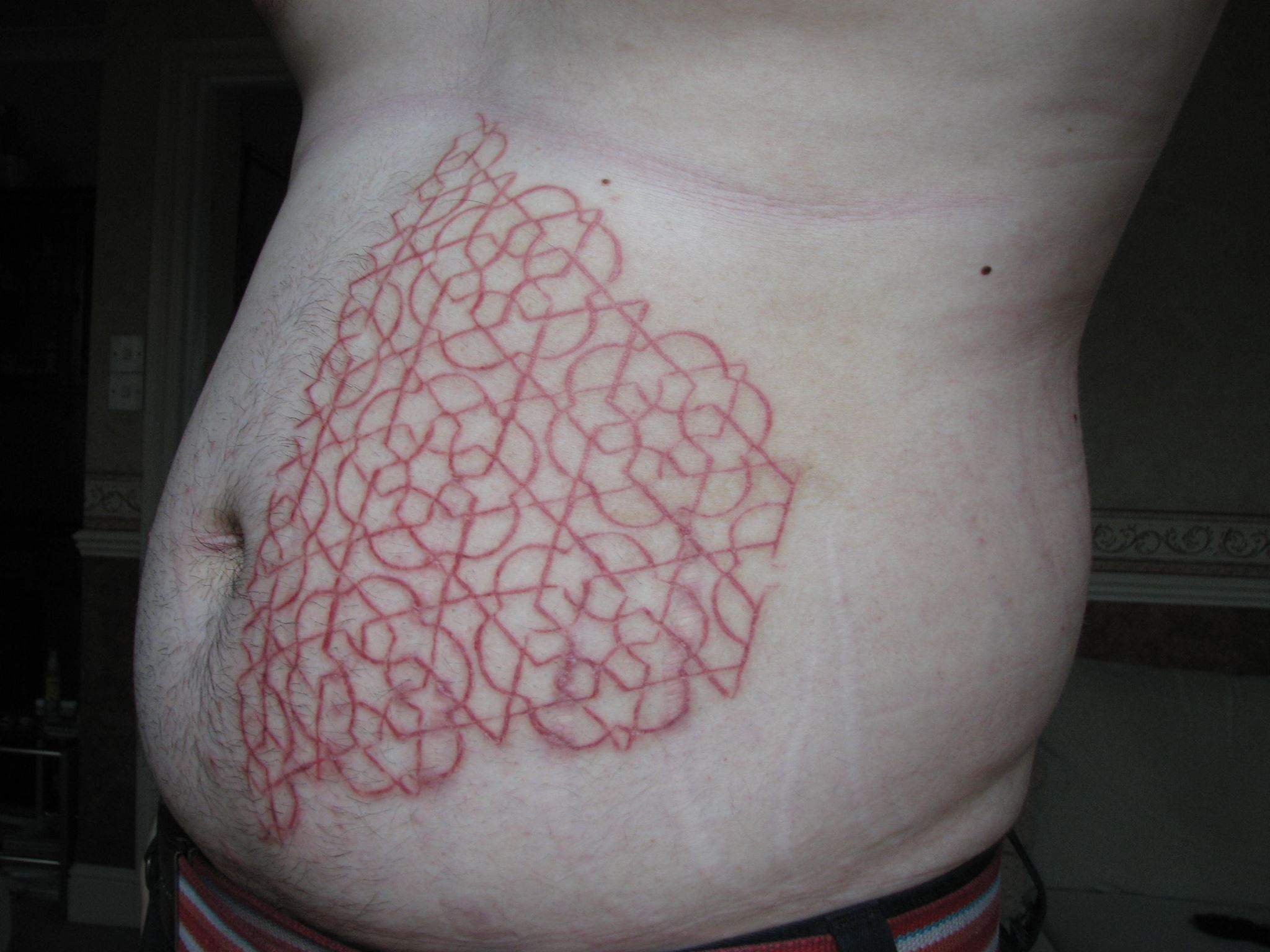 Cool Scarification Design Tattoo On Stomach
