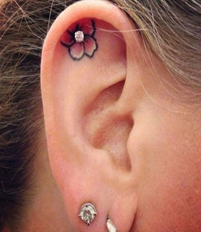 Cute Flower Tattoo In Ear And Earlobe Piercing With stud