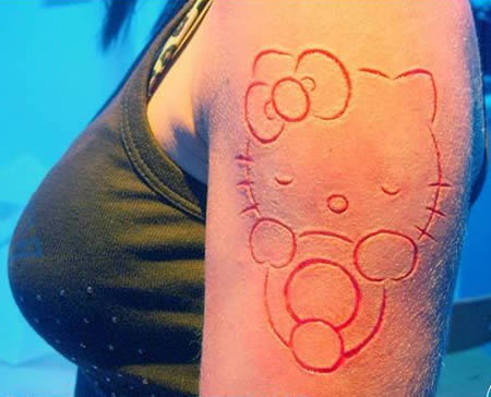 Cute Hello Kitty Scarification Tattoo On Left Half Sleeve For Girls
