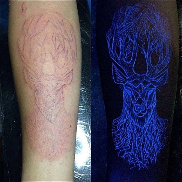 Deer In Daylight And UV Light Tattoo On Forearm