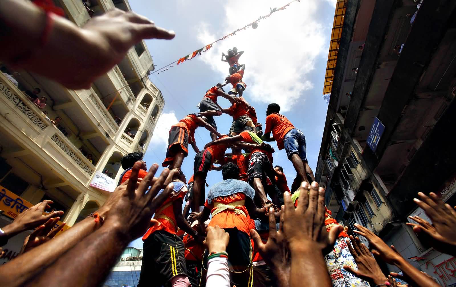 Devotees Build A Pyramid In An Attempt To Break The Dahi Handi On The Janamashtmi Festival Celebration