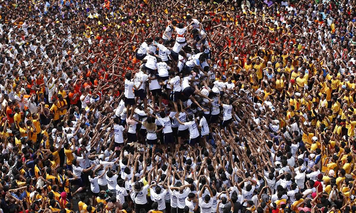 Devotees Try To Form A Human Pyramid To Break Dahi Handi During The Janamashtmi Festival
