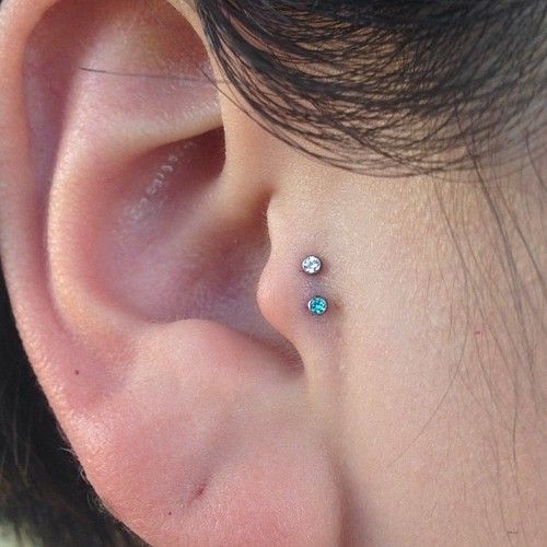 Double Tragus Piercing With Blue And Silver Anchors